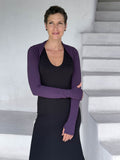 caraucci-woman-wearing-purple-sleeve-shrug-layered-over-cream-dress-with-thumbhole-detail #color_plum