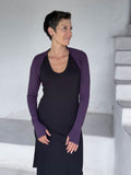 caraucci-woman-wearing-purple-sleeve-shrug-layered-over-cream-dress-with-thumbhole-detail #color_plum