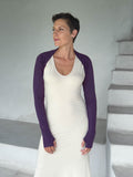 caraucci-woman-wearing-purple-sleeve-shrug-layered-over-cream-dress-with-thumbhole-detail #color_plum